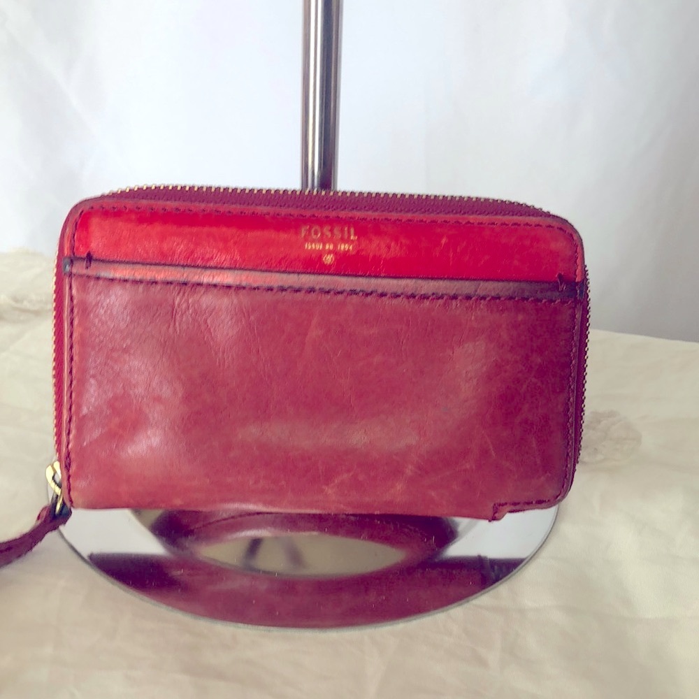 FOSSIL red genuine leather wallet. Zips all the way around. Holds 7 cards.